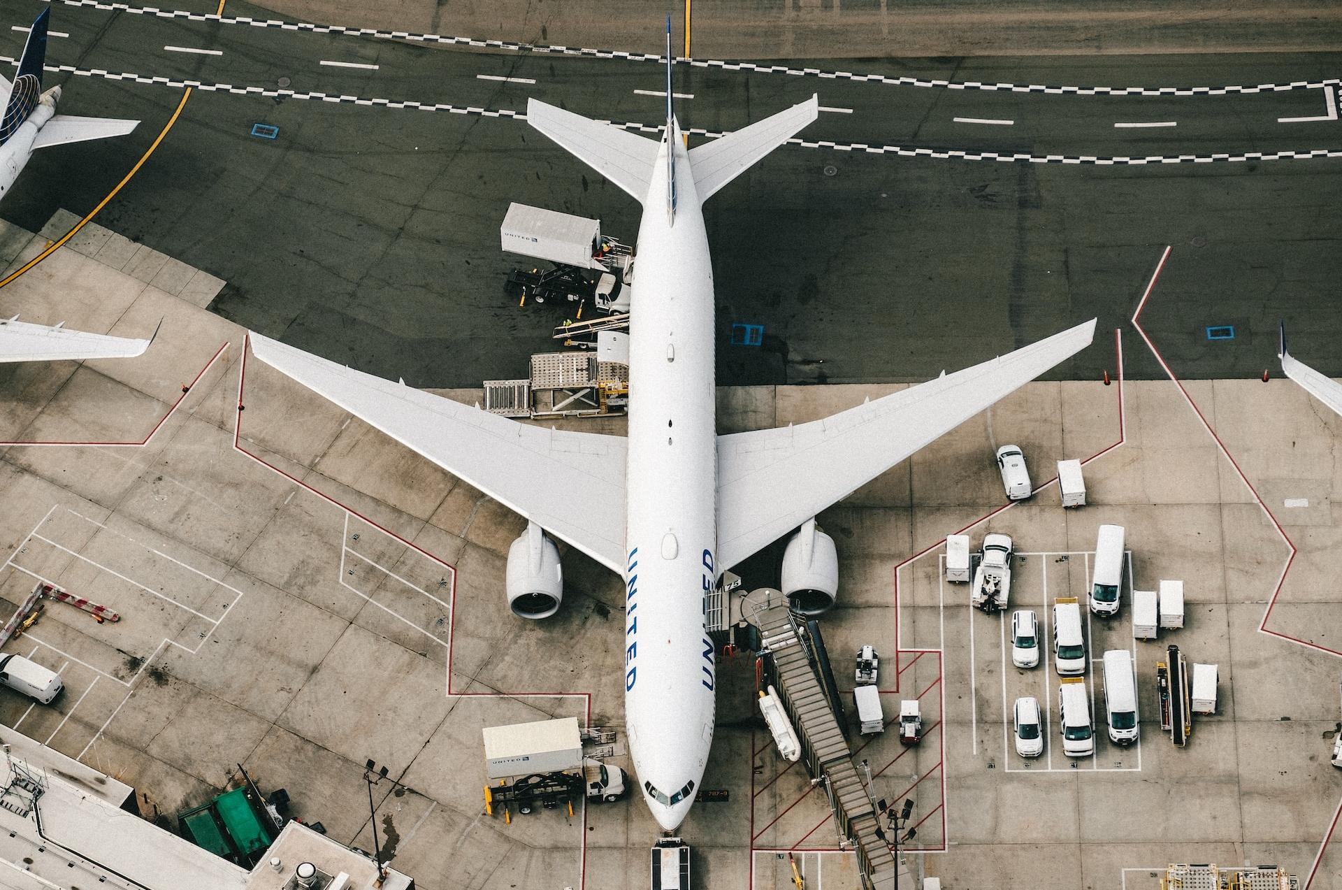 white and blue airplane on airport during daytime